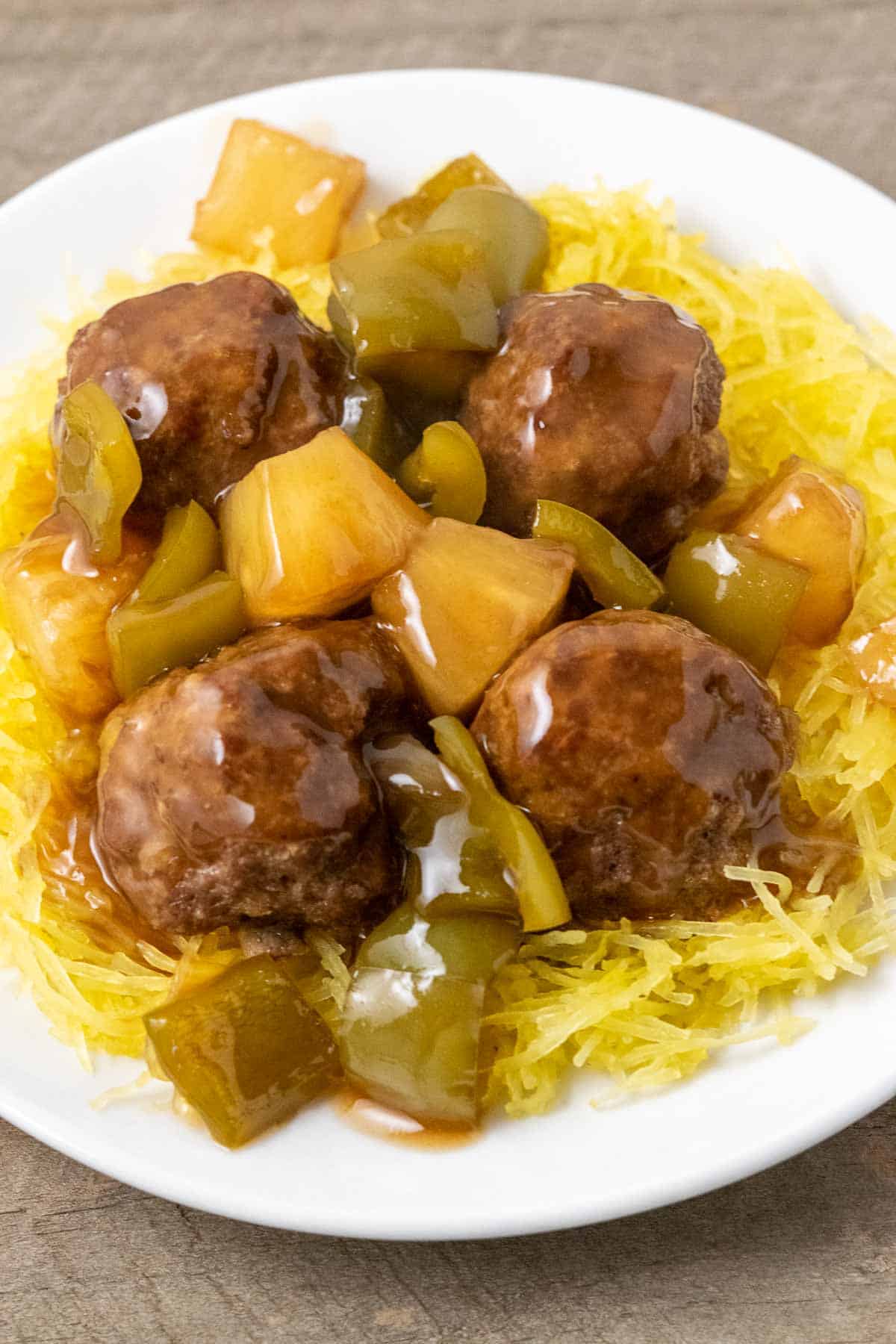a plate filled with Spaghetti Squash with Hawaiian Meatballs, pineapple, and green peppers.