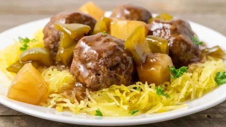 a plate filled with Spaghetti Squash and Hawaiian Meatballs, pineapple, and green peppers.