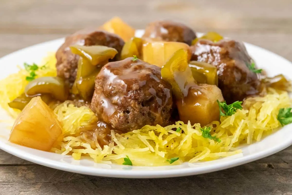 a plate filled with Spaghetti Squash and Hawaiian Meatballs, pineapple, and green peppers.