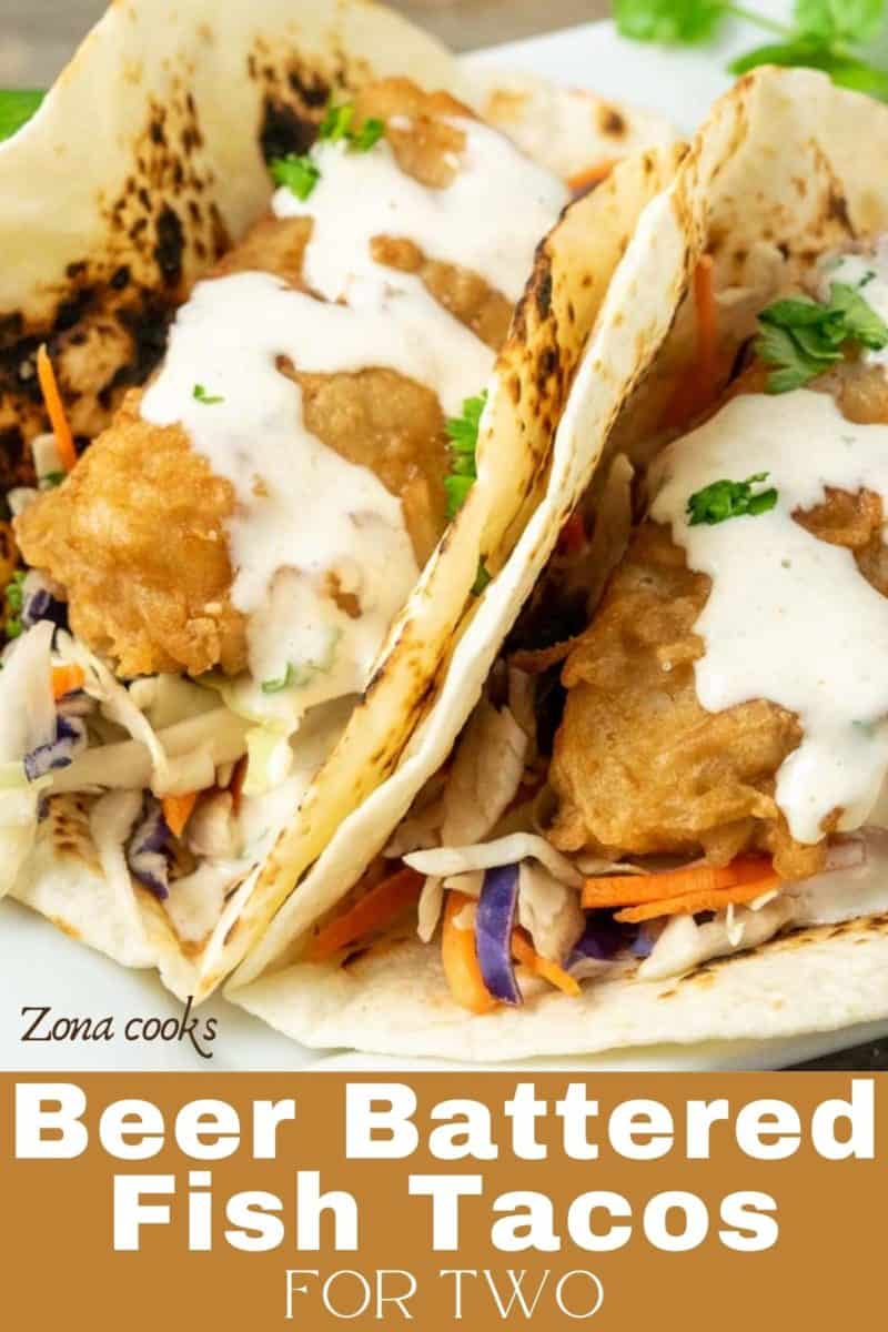 two Baja Fish Tacos with coleslaw on a plate.