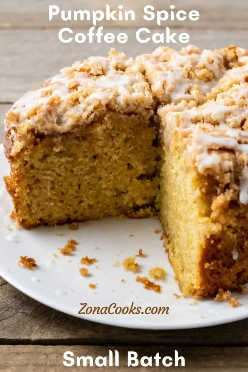 a pumpkin coffee cake with streusel on a plate.