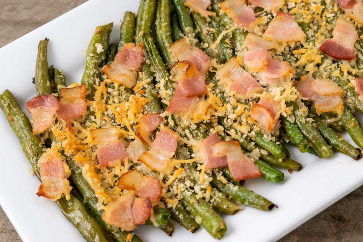 Roasted Green Beans with Bacon and Parmesan cheese on a plate.