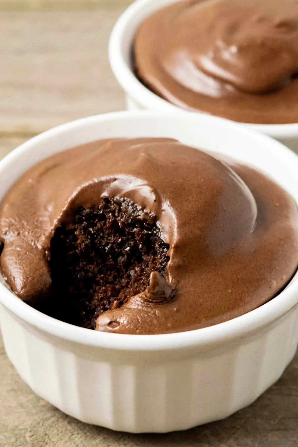 two small batch chocolate cakes in ramekin dishes.