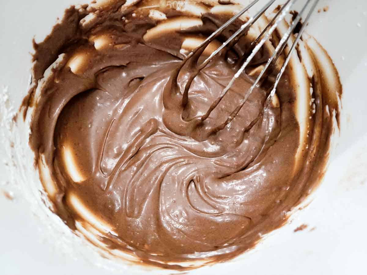 chocolate buttercream frosting whisked in a bowl.