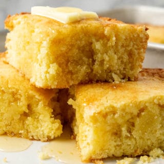 thick moist cornbread topped with butter and honey.