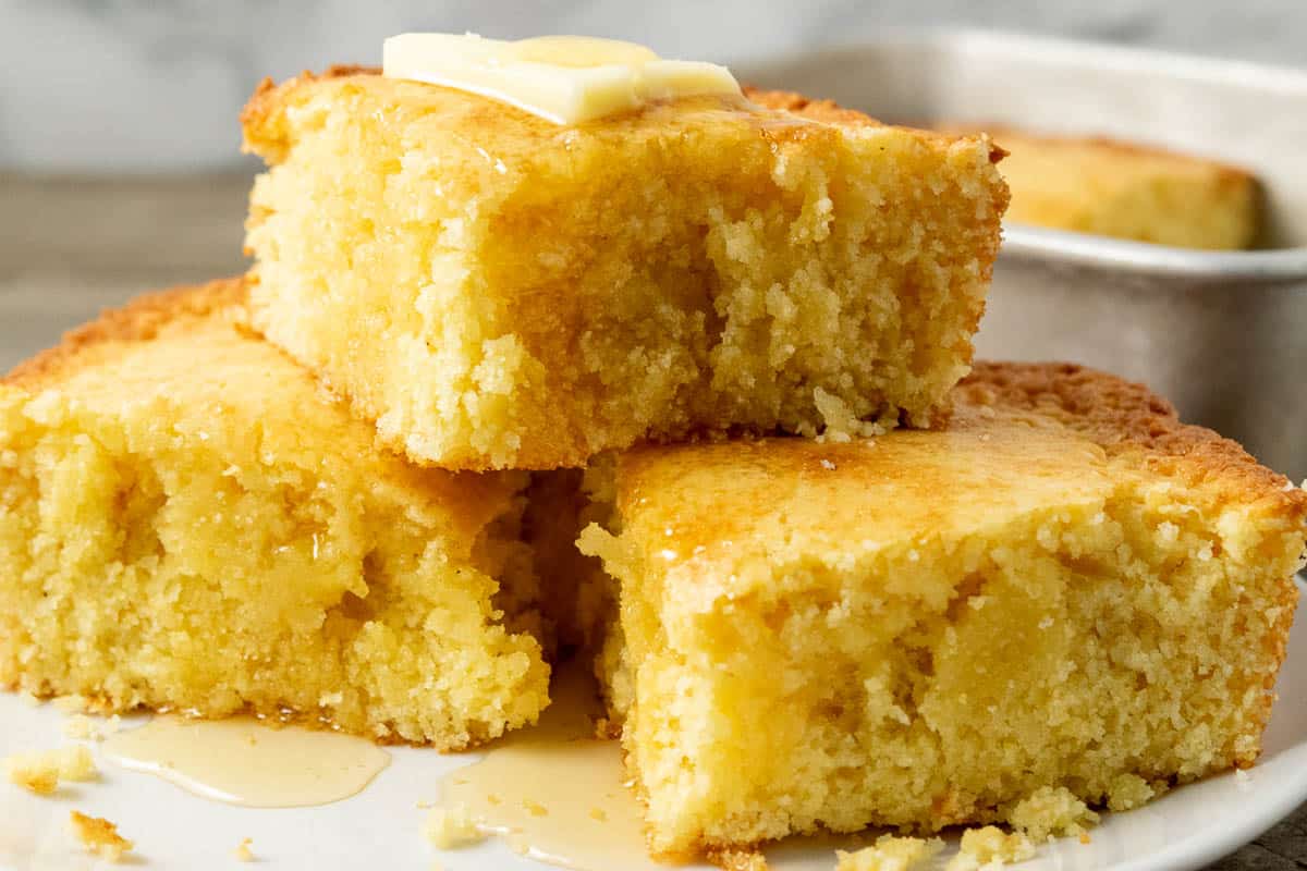 thick moist cornbread topped with butter and honey.