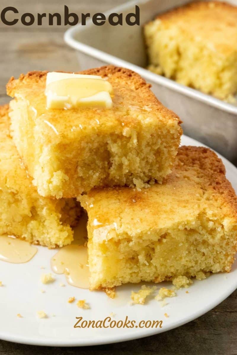 3 slices of cornbread topped with butter and honey on a plate.