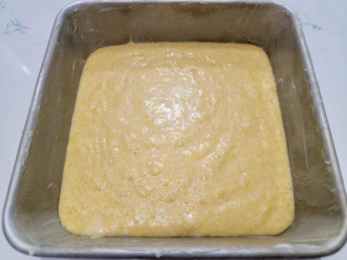 corn bread batter poured into a greased 6 inch square cake pan.