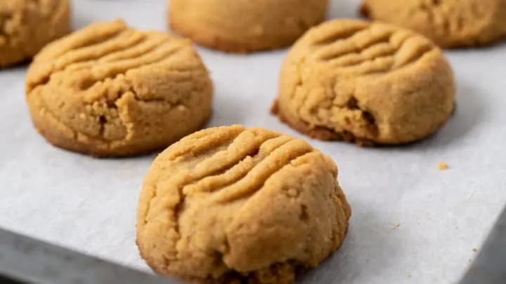 Peanut Butter Cookies on parchment lined cookie sheet.
