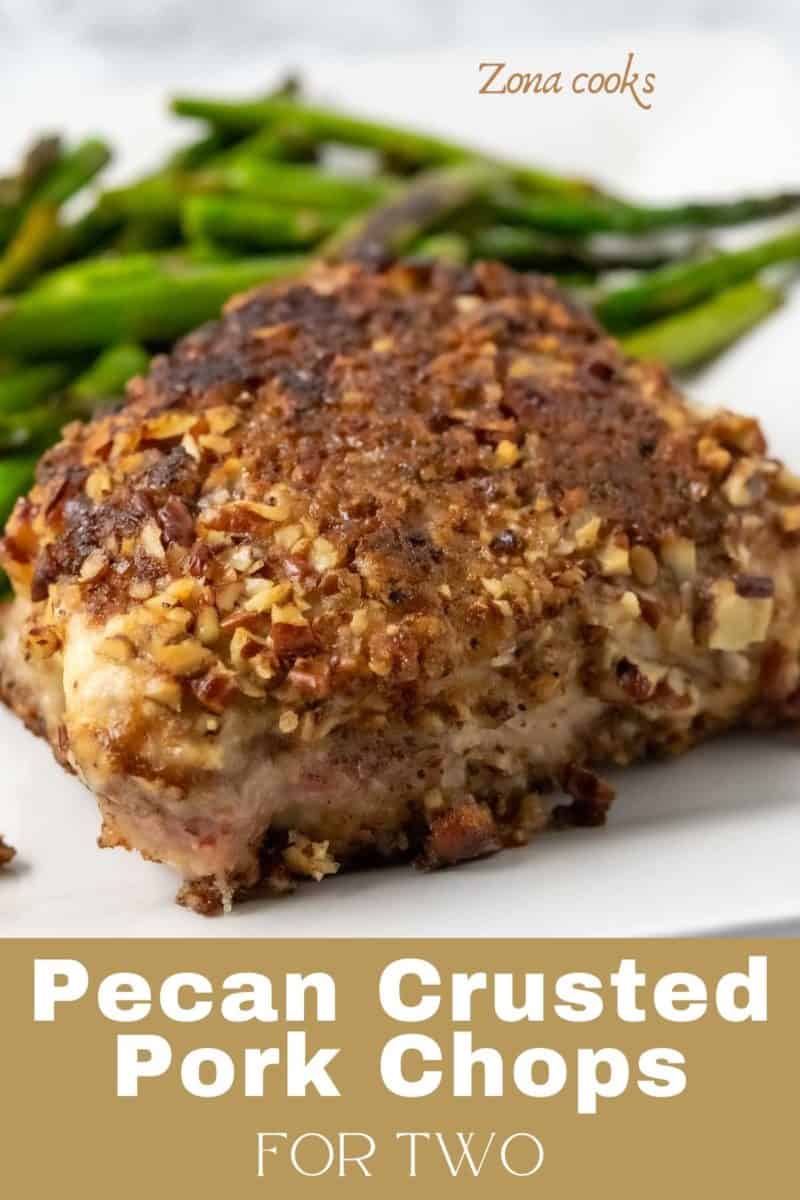 a Pork Chop with pecan crust and asparagus on a plate.