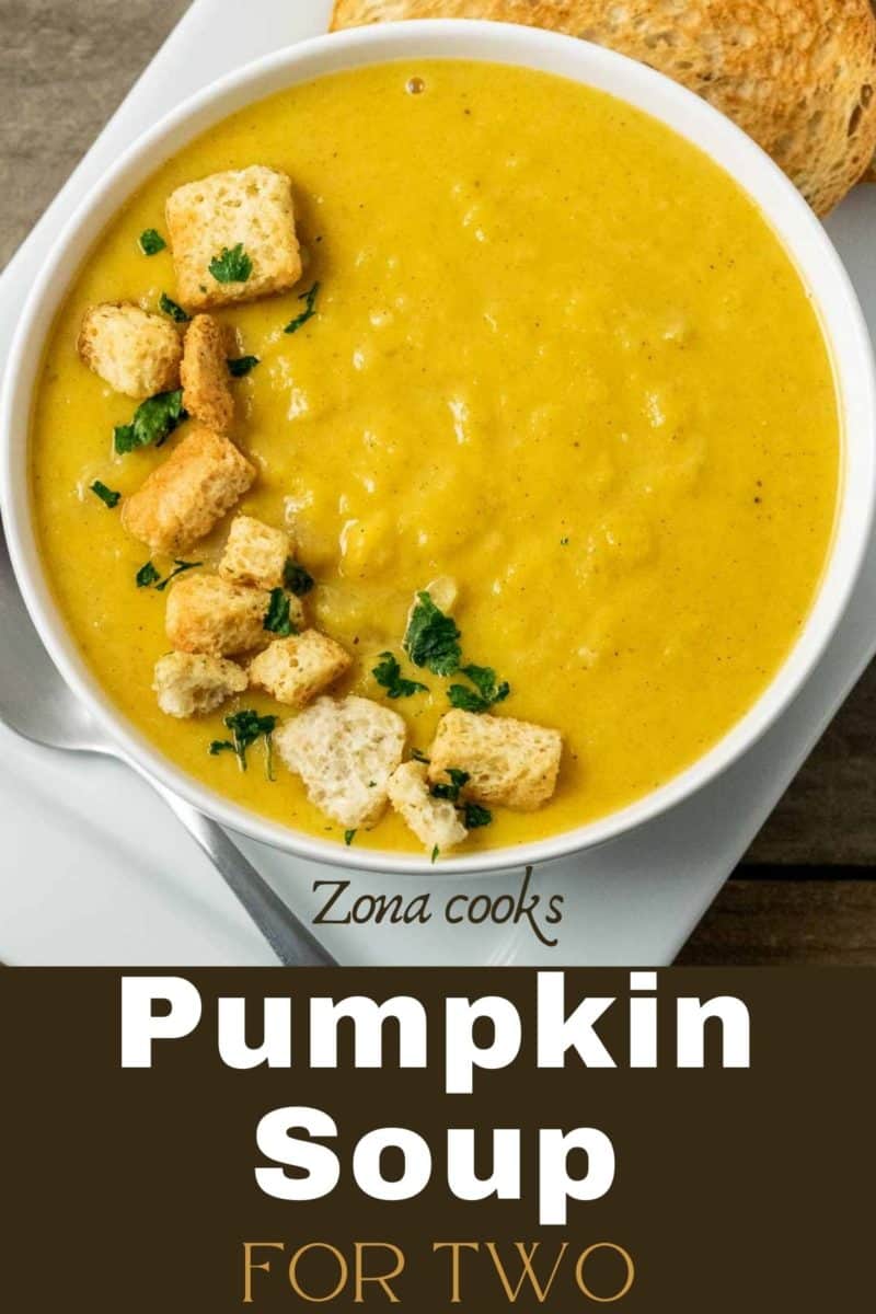 a bowl filled with Pumpkin Soup and croutons.