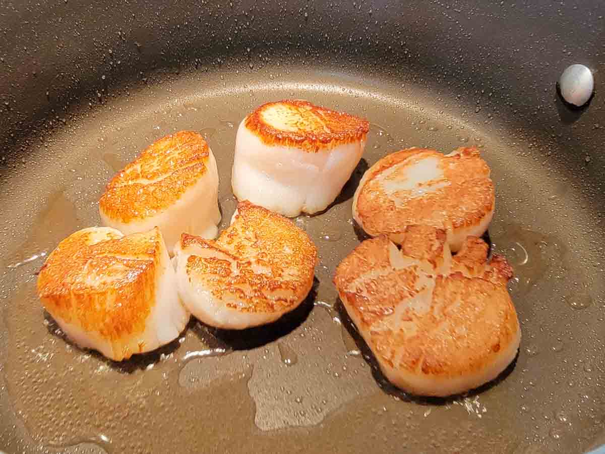 sea scallops cooking in oil.