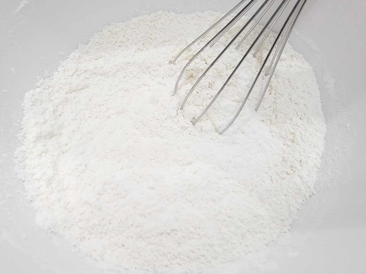 flour, baking powder, baking soda, and salt whisked together in a bowl.