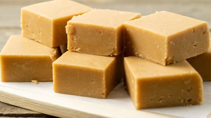 9 Peanut Butter Fudge squares stacked in a pile.