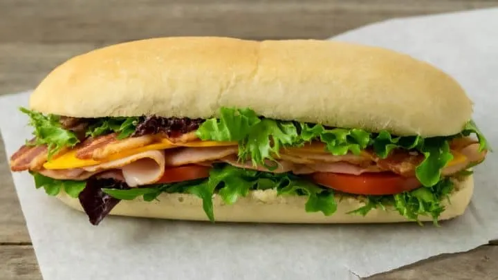 a homemade sub bun filled with sandwich ingredients.