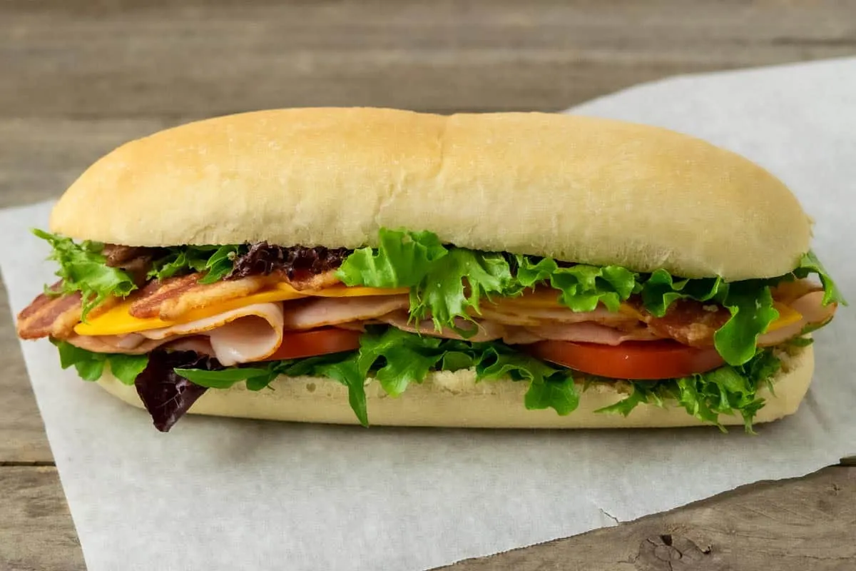 a homemade sub bun filled with sandwich ingredients.