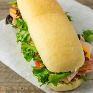 a homemade hoagie roll filled with sub sandwich ingredients.