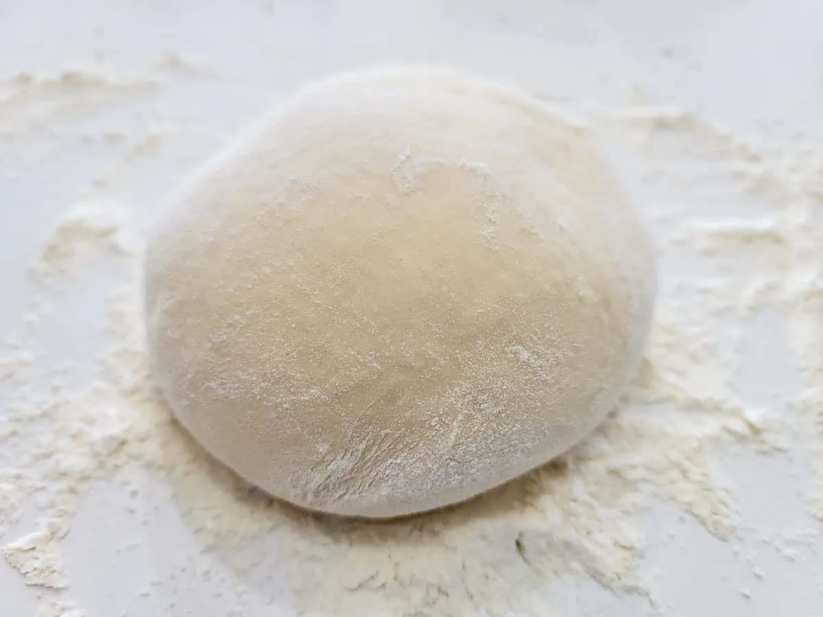 soft dough ball coated in flour.