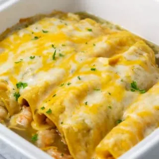 a casserole dish filled with shrimp enchiladas for two.