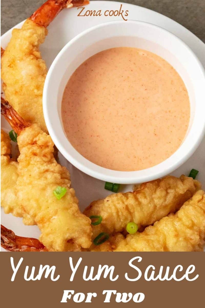 a bowl of yum yum sauce on a plate with shrimp tempura.