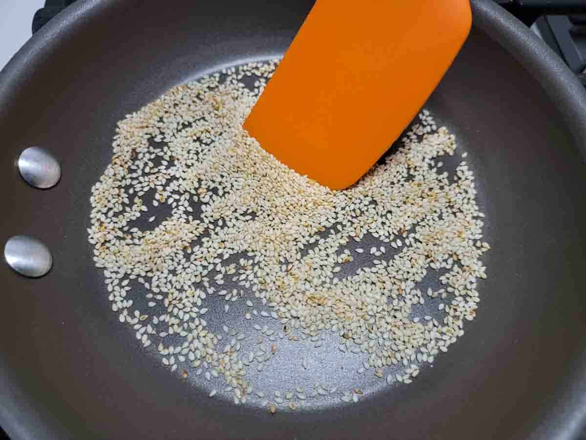 sesame seeds cooking in a dry skillet.