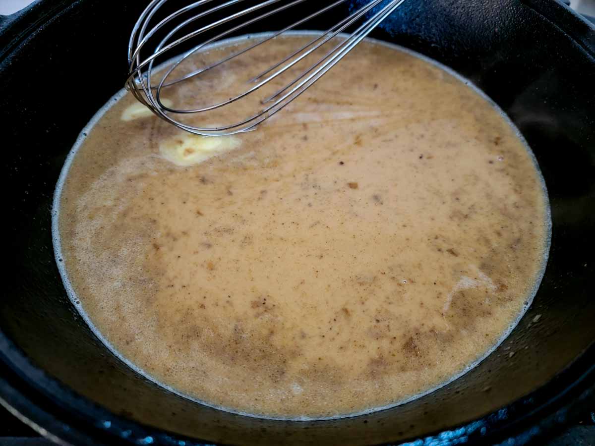 heavy cream and butter added to the bourbon sauce in the cast iron skillet.