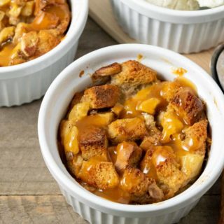 Pineapple Banana Bread Pudding topped with caramel sauce and a side of ice cream.