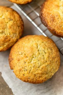 top down view of 3 jumbo muffins on parchment paper and a cooling rack.