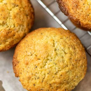 top down view of 3 jumbo muffins on parchment paper and a cooling rack.