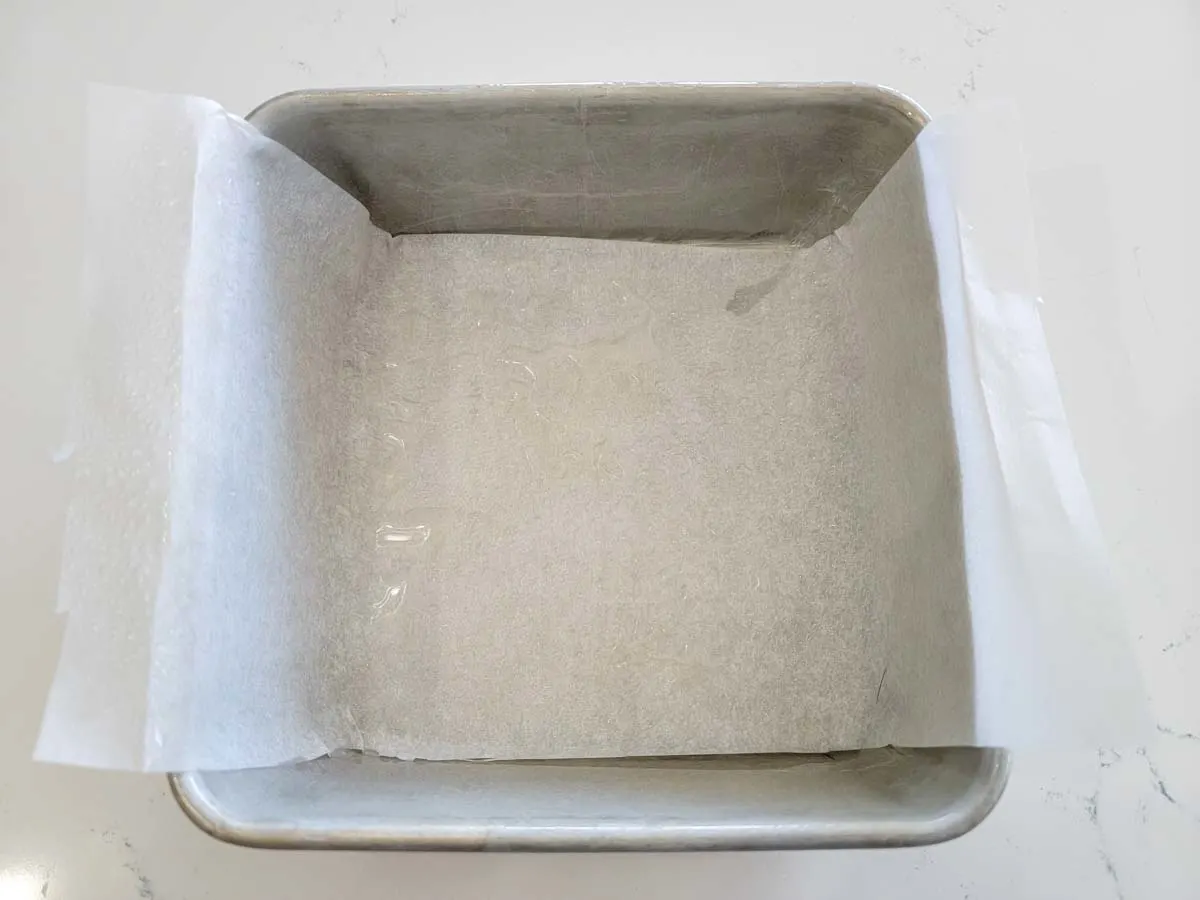 a cake pan layered with parchment paper and non-stick spray.