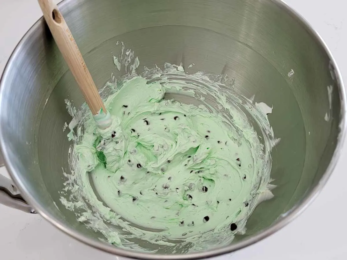 mint chocolate chip cheesecake filling mixed in a bowl.