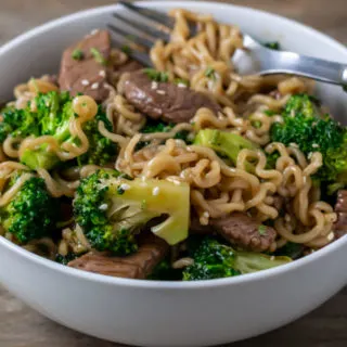 broccoli and chinese noodles mixed with sliced sirloin.