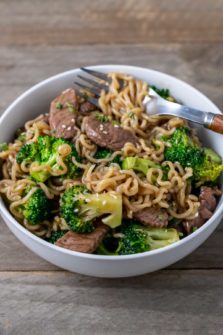 broccoli and chinese noodles mixed with sliced sirloin.