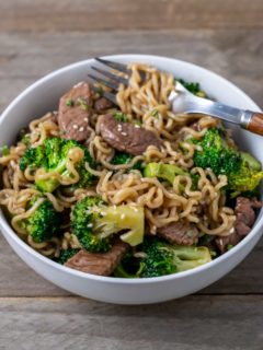 broccoli and chinese noodles mixed with sliced sirloin.