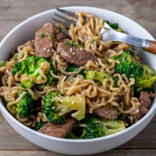 broccoli and chinese noodles mixed with sliced sirloin.