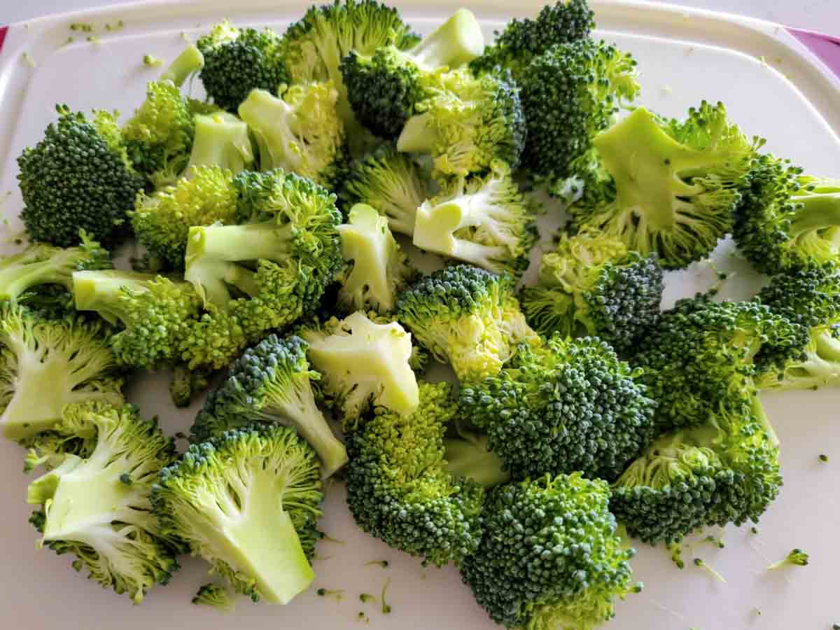 broccoli chopped on a cutting board.