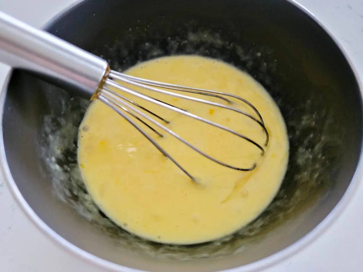 eggs, heavy cream, and salt whisked in a bowl.