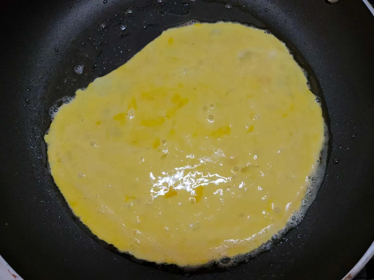 egg and heavy cream mixture in a frying pan.