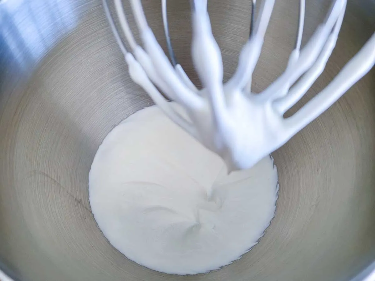 heavy cream whisked in a bowl.