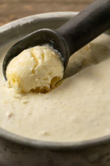 No Churn Banana Pineapple Ice Cream with an ice cream scoop in it.