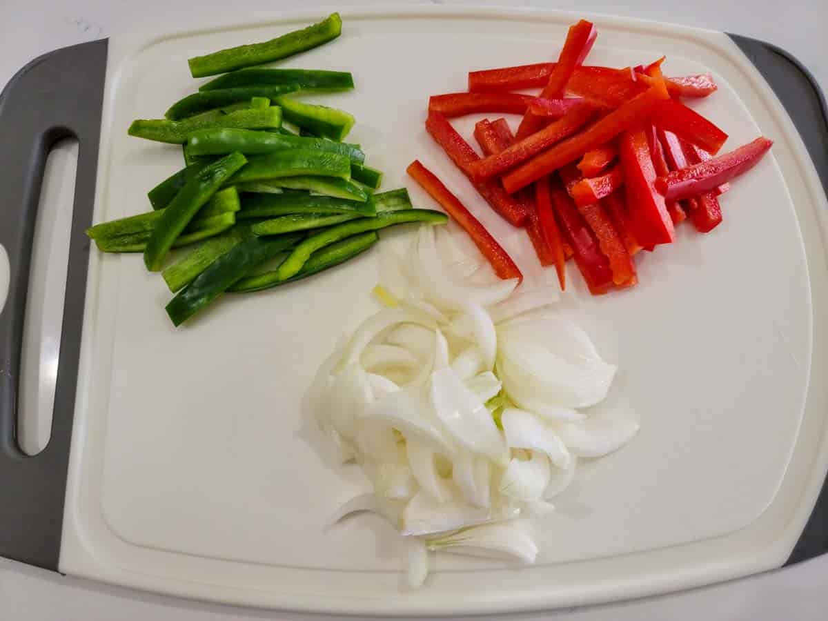 green pepper, red pepper, and onions cut into strips.