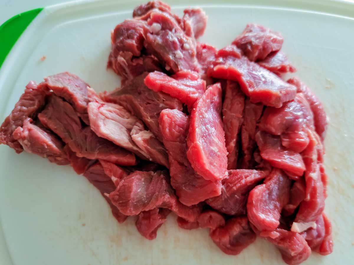 sliced sirloin steak on a cutting board.
