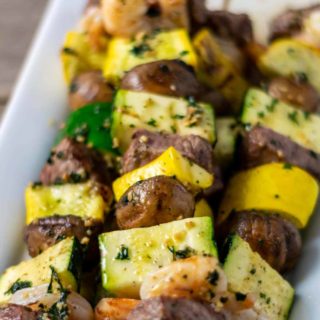 Grilled Steak and Shrimp Kabobs on a plate.