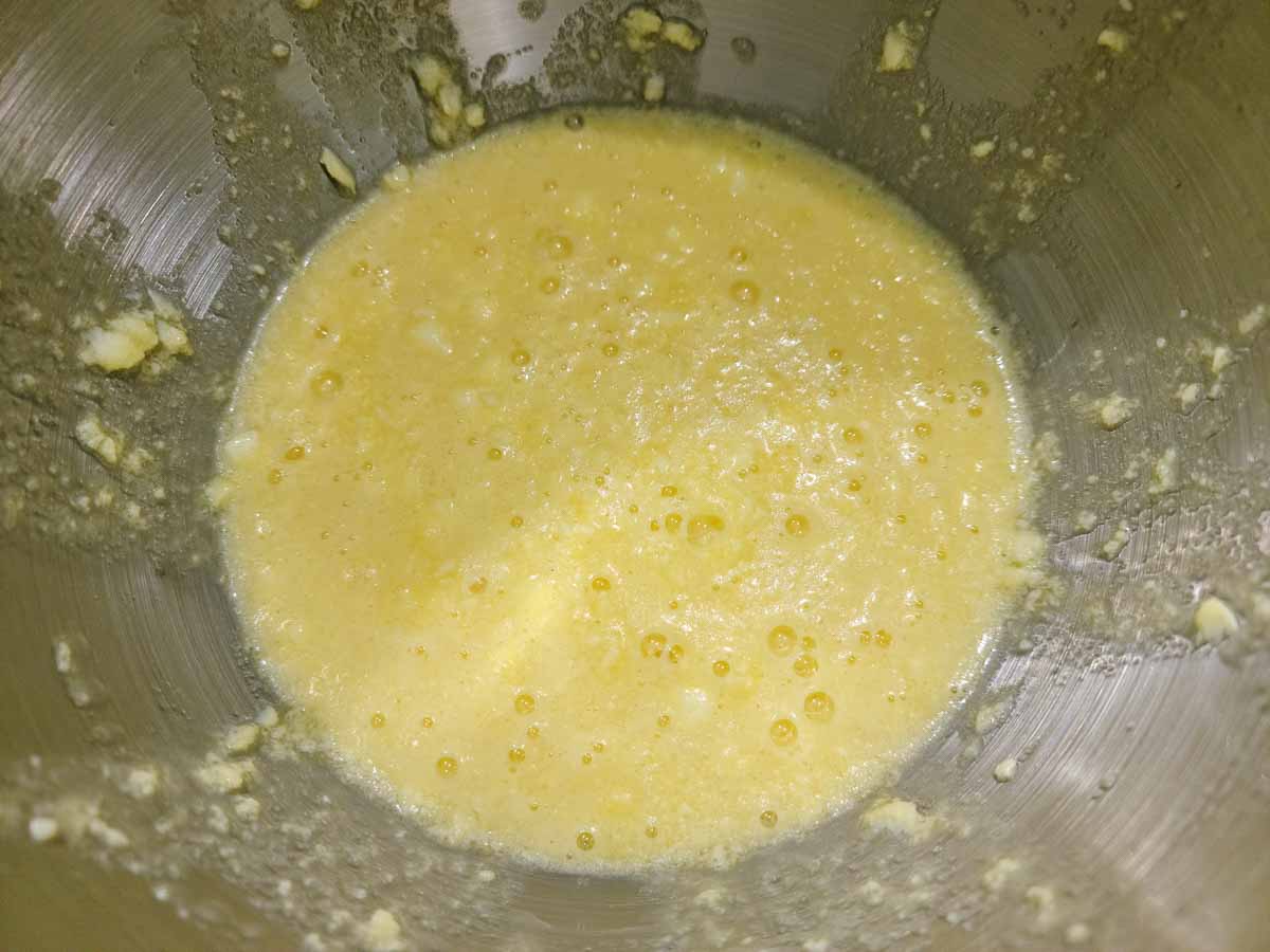 butter, sugar, eggs, and vanilla creamed together in a bowl.