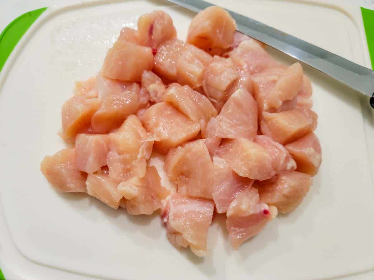 diced chicken on a cutting board.