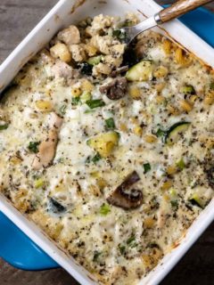 Pasta with Chicken Mushrooms and Zucchini in a casserole dish with a spoon.