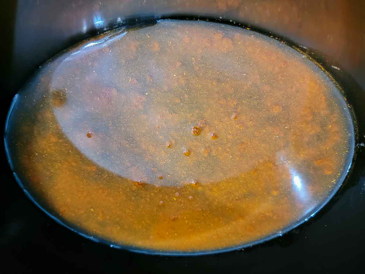 chicken broth and taco seasoning in a crock pot.