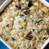 Pasta with Chicken Mushrooms and Zucchini in a casserole dish with a spoon.