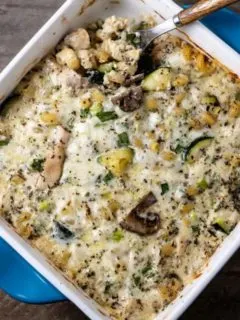 Pasta with Chicken Mushrooms and Zucchini in a casserole dish with a spoon.