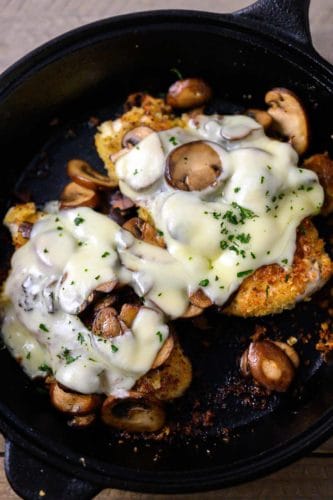 Mushroom Swiss Chicken in a cast iron skillet.